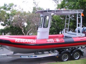 glaucus boat on a trailer in yard