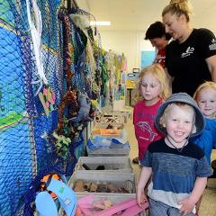 Children interact with a display